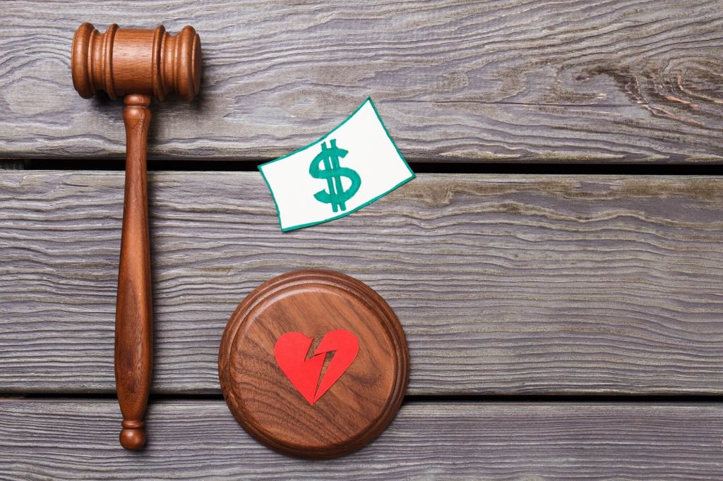 Image of a judge's gavel and money indicating the cost of the divorce fees